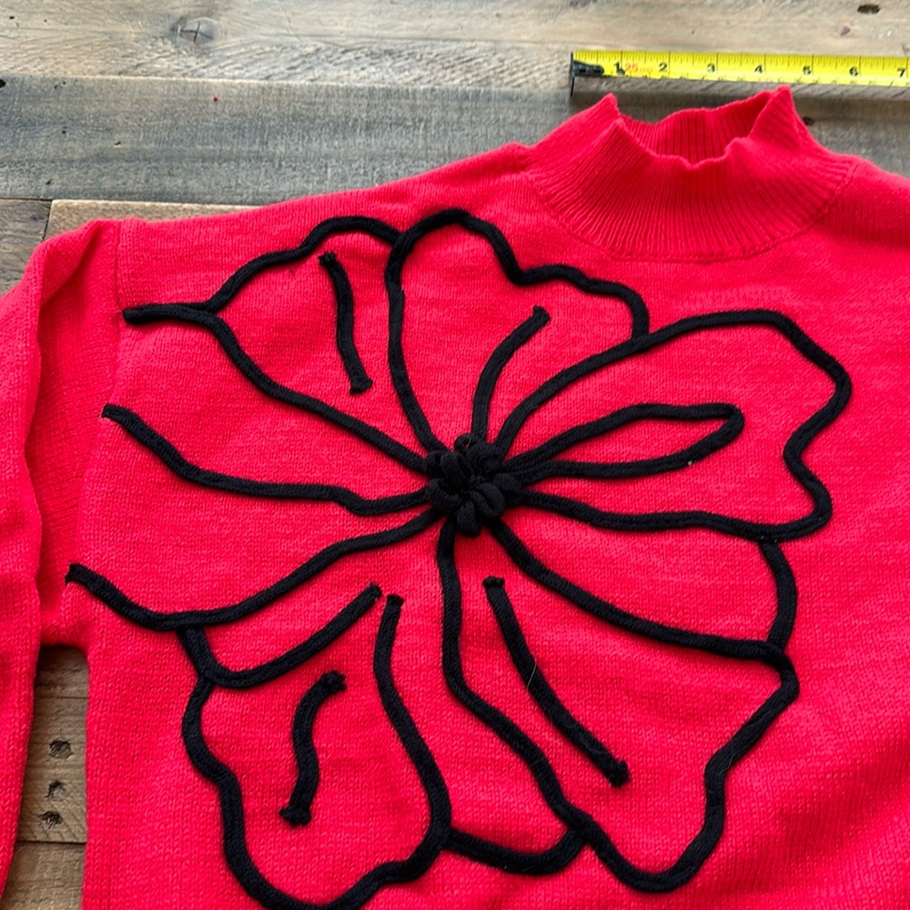 New womens sweater crew neck unused red with black flower outline on front & arm